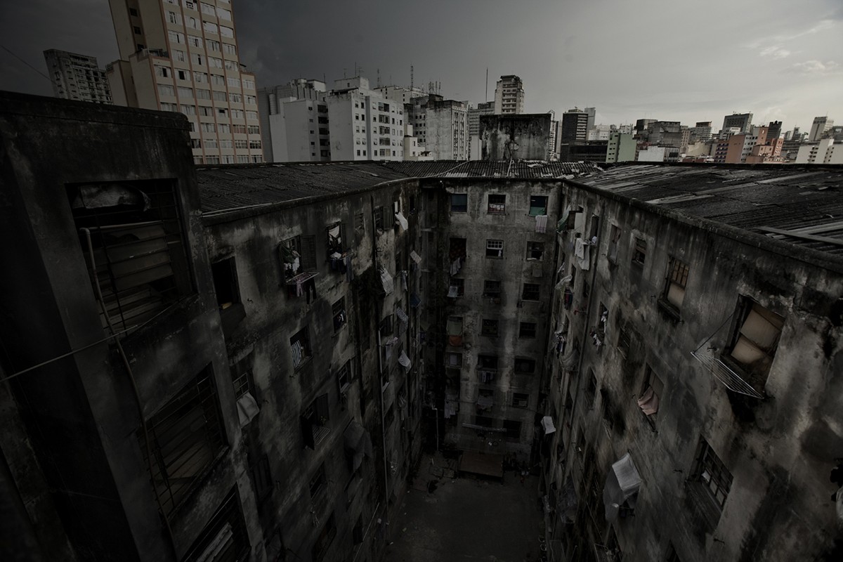 Black and white photograph of a dilapidated apartment building.