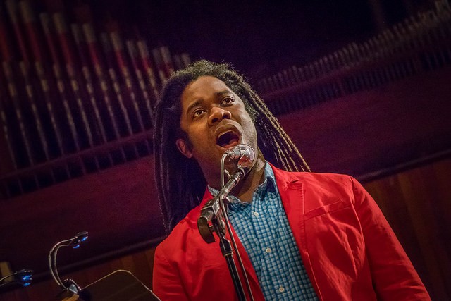 A man sings into a microphone.