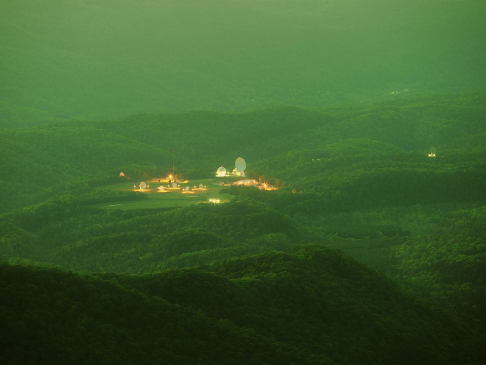 Large round structures and lights in a field in the middle of a forest