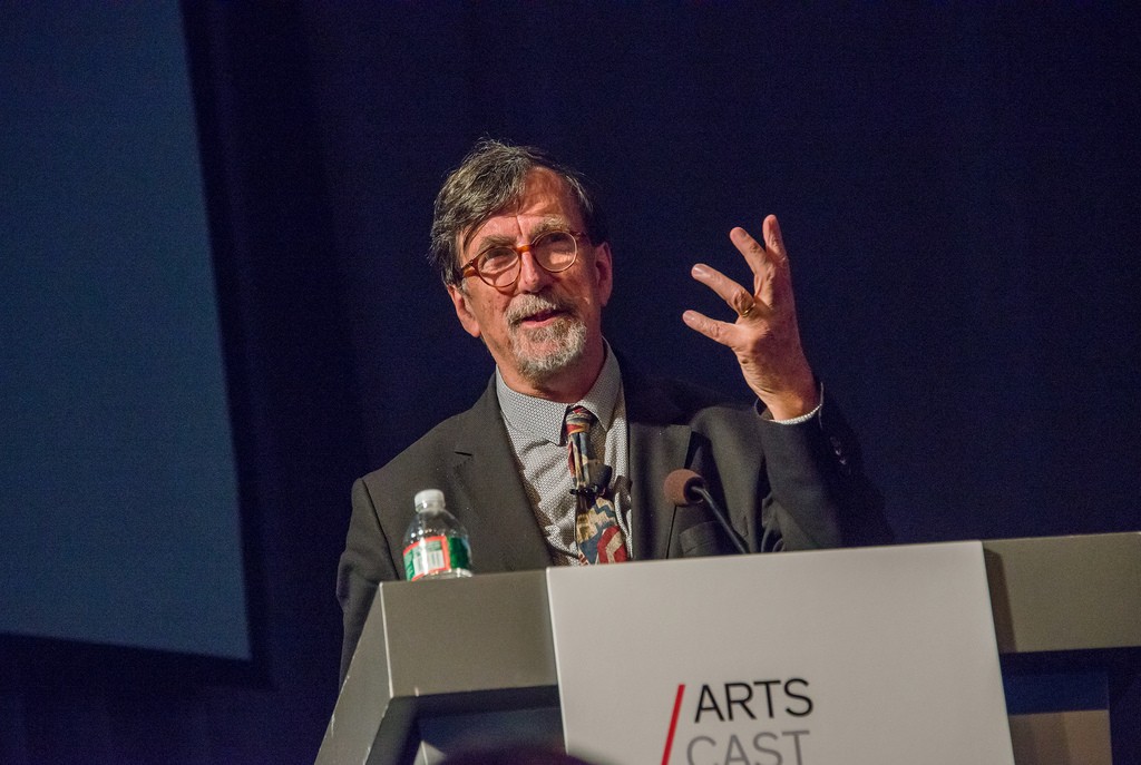 A man speaks at a podium.