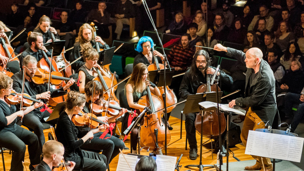 CAST Faculty Director Evan Ziporyn conducts his arrangement of David Bowie's Blackstar, performed by Maya Beiser with the Ambient Orchestra. Photo: Justin Knight.