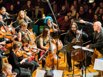 CAST Faculty Director Evan Ziporyn conducts his arrangement of David Bowie's Blackstar, performed by Maya Beiser with the Ambient Orchestra. Photo: Justin Knight.