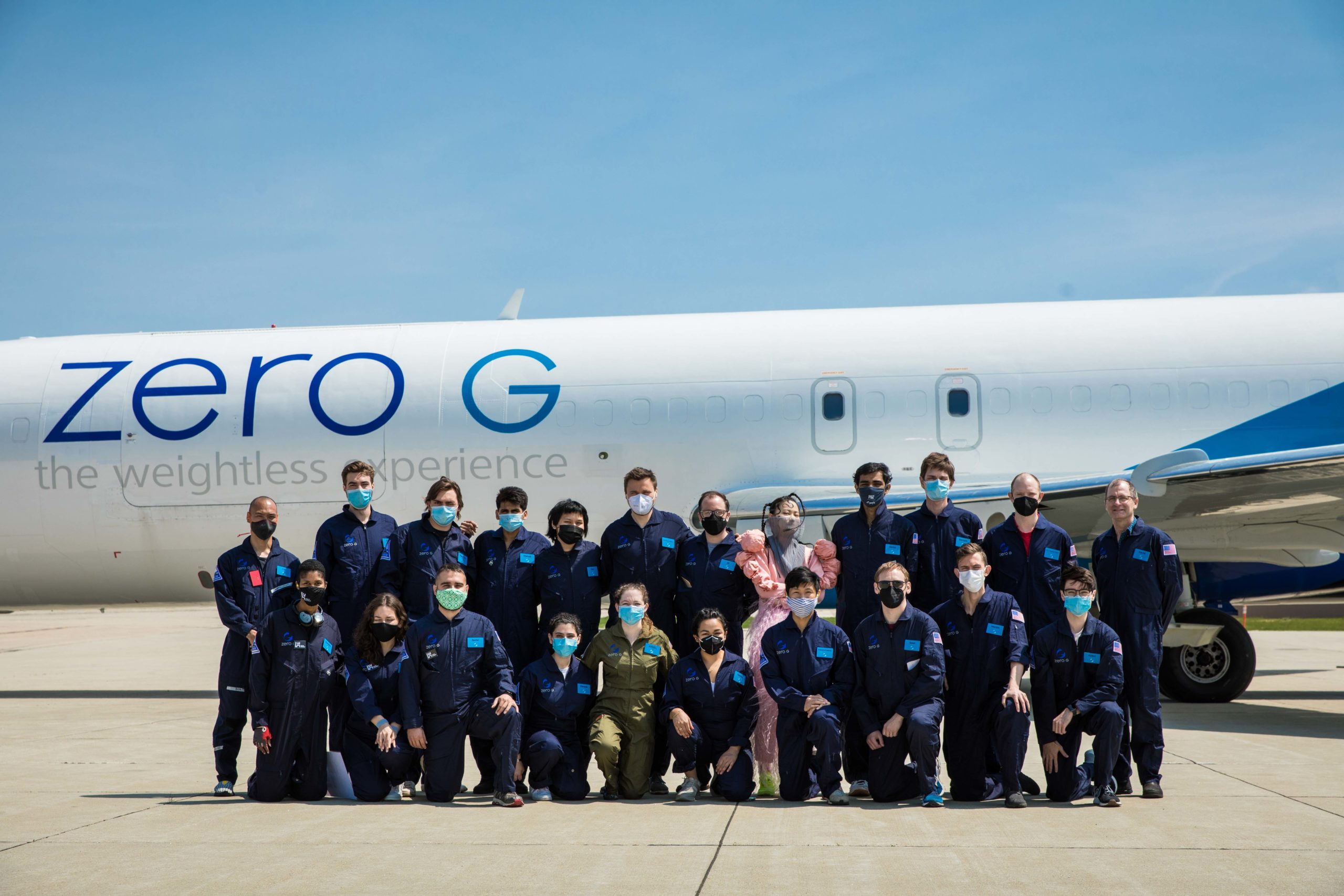 Group of people in front of plane