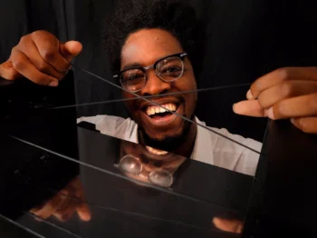 A person holding strings on top of a mirror.